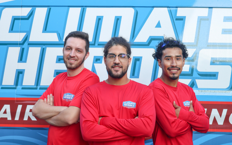 3 installers smiling and posing in front of a van