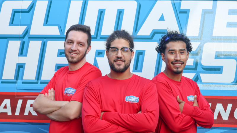 3 installers smiling and posing in front of a van